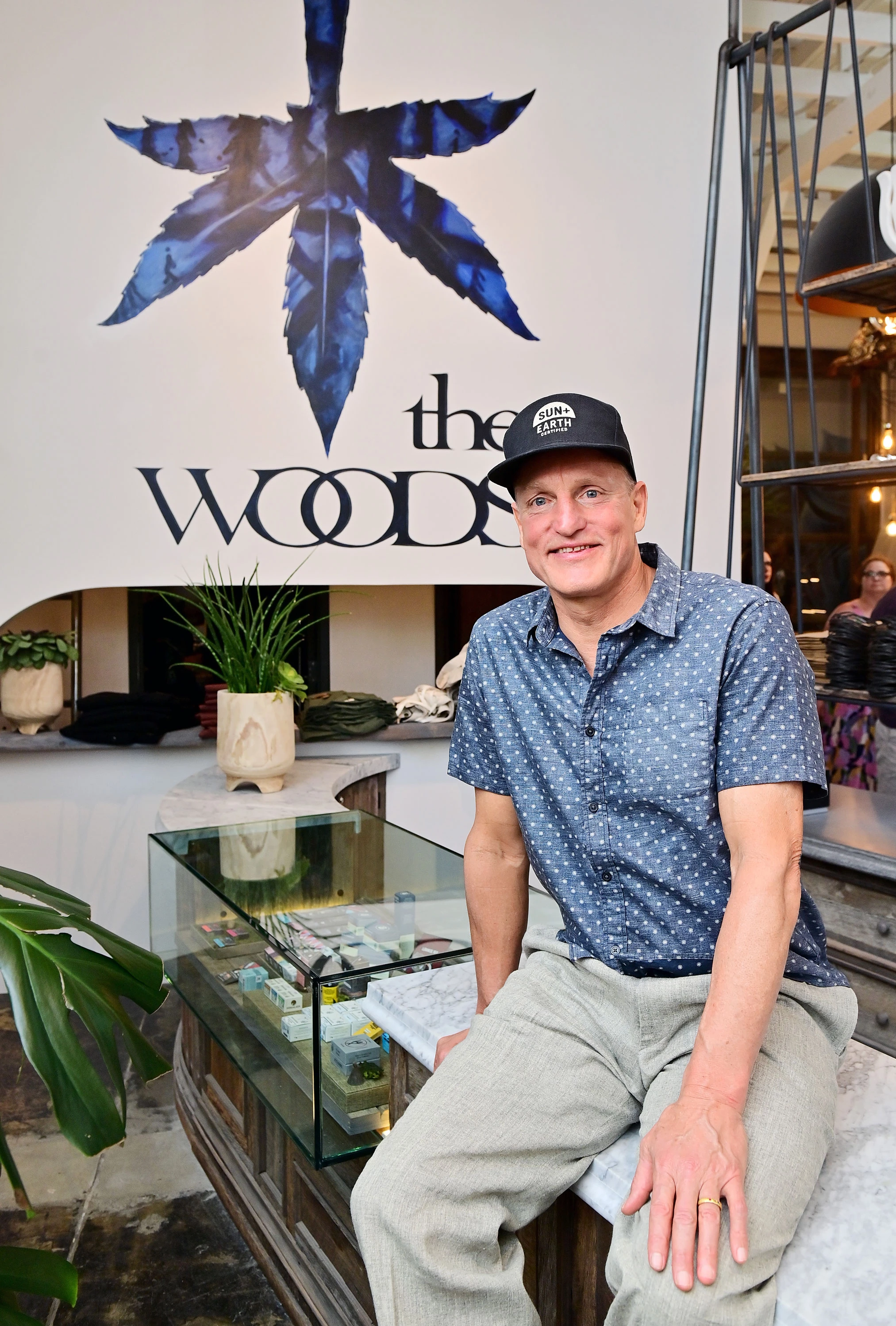 Woody Harrelson sitting The Woods Dispensary
