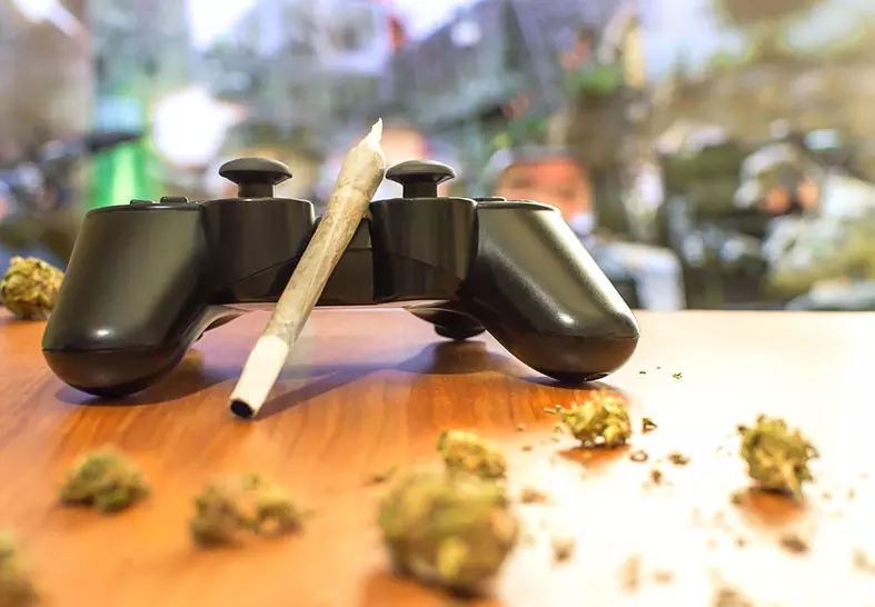 weed joint laying on video game controller photo